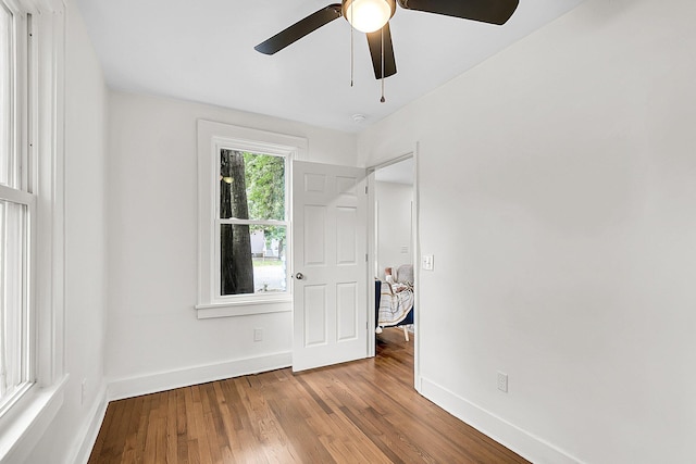 unfurnished room featuring ceiling fan and hardwood / wood-style flooring