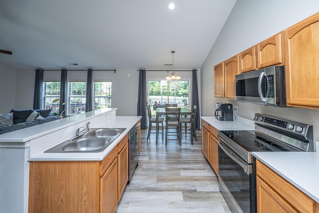 5128 Thornton Dr, Summerville, SC 29485 - kitchen with stainless steel appliances, a sink, light wood finished floors, light countertops, and lofted ceiling