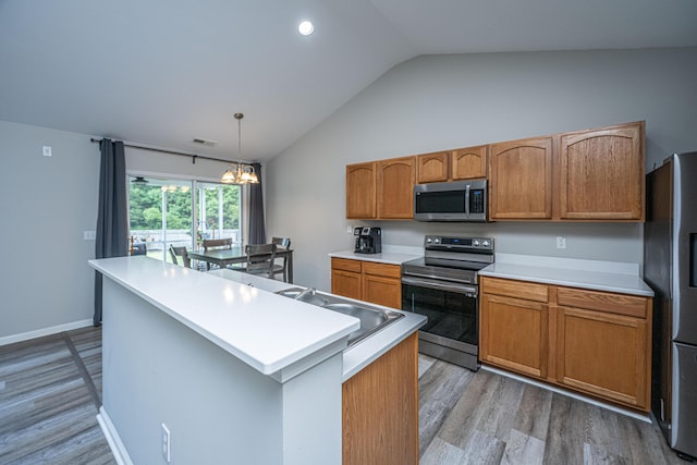 5128 Thornton Dr, Summerville, SC 29485 - kitchen featuring appliances with stainless steel finishes, lofted ceiling, light wood-style flooring, a sink, and light countertops