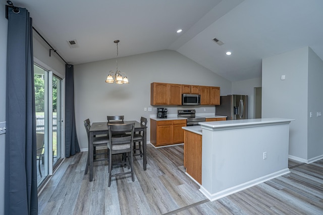 5128 Thornton Dr, Summerville, SC 29485 - kitchen with stainless steel appliances, light countertops, light wood-type flooring, lofted ceiling, and a chandelier