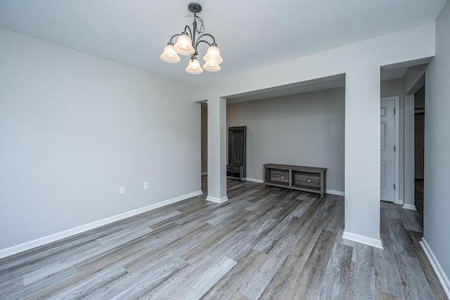 5128 Thornton Dr, Summerville, SC 29485 - unfurnished living room featuring wood finished floors, a chandelier, and baseboards