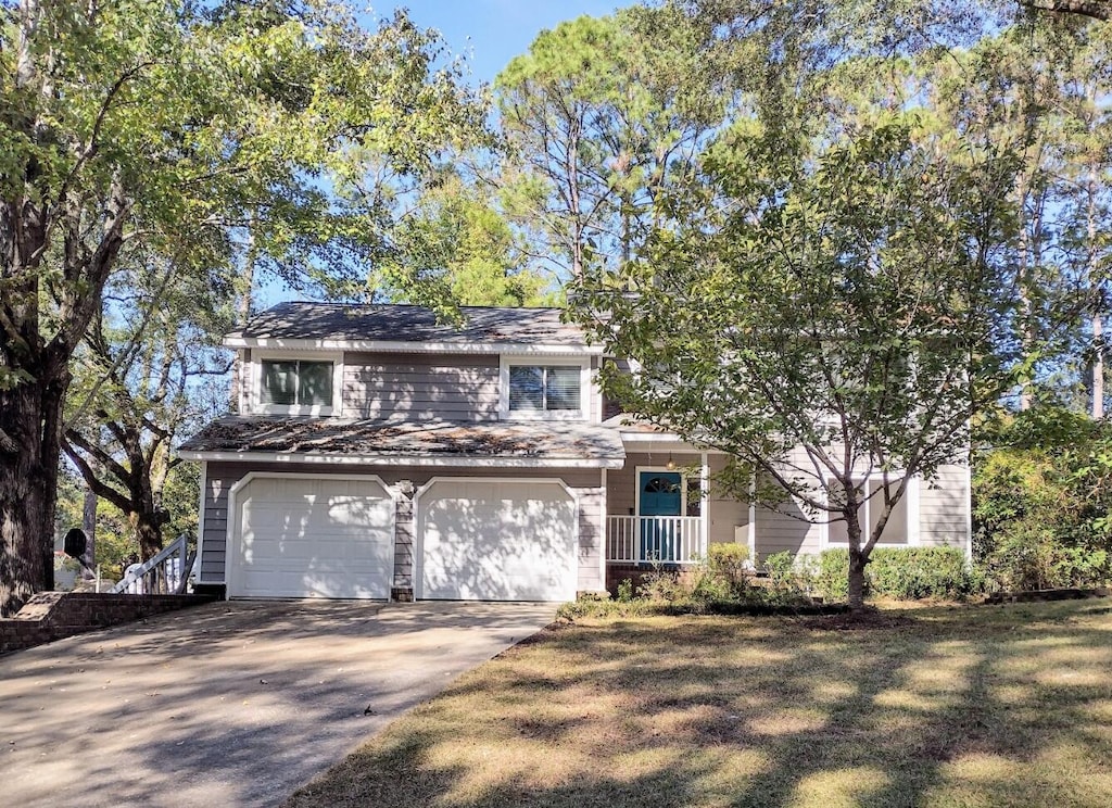 view of front of property with a front lawn and a garage