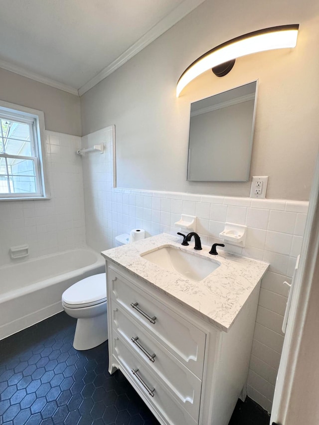 full bathroom featuring tiled shower / bath combo, tile walls, tile floors, toilet, and oversized vanity