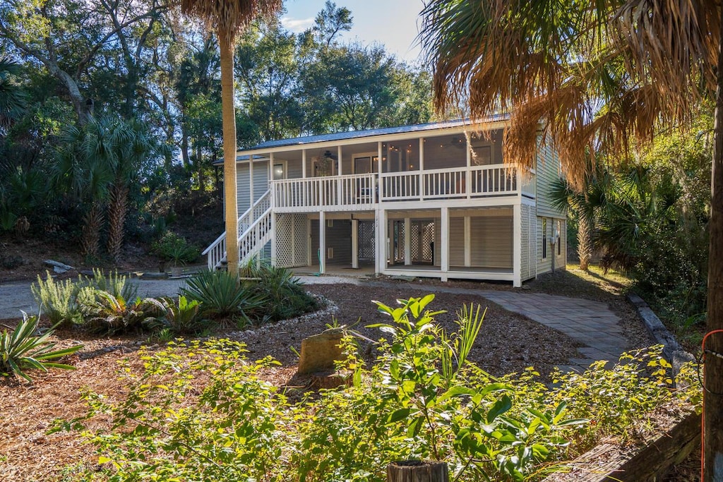 rear view of property featuring a sunroom