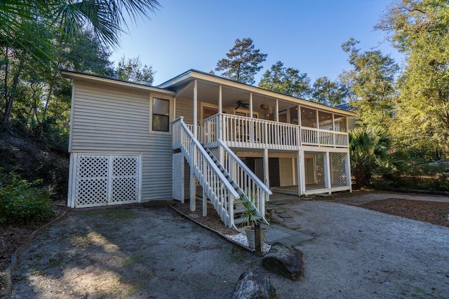 view of front of home featuring a sunroom and ceiling fan