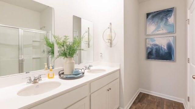 326 Watersglen Dr, Summerville, SC 29486 - bathroom featuring wood finished floors, double vanity, an enclosed shower, and baseboards