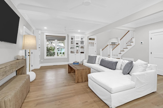 living room featuring beam ceiling, ceiling fan, and light hardwood / wood-style flooring