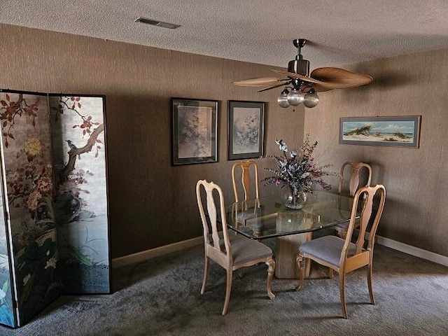 unfurnished dining area with ceiling fan, a textured ceiling, and carpet floors