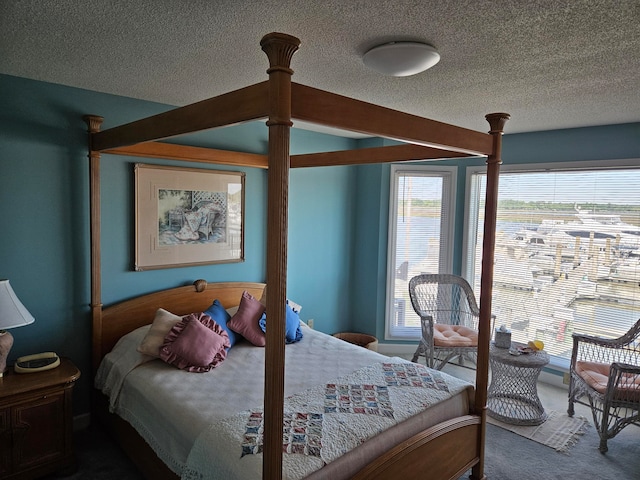 bedroom featuring a textured ceiling and carpet flooring