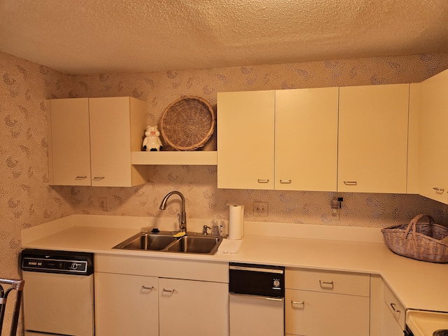 kitchen featuring open shelves, a sink, a textured ceiling, dishwasher, and light countertops