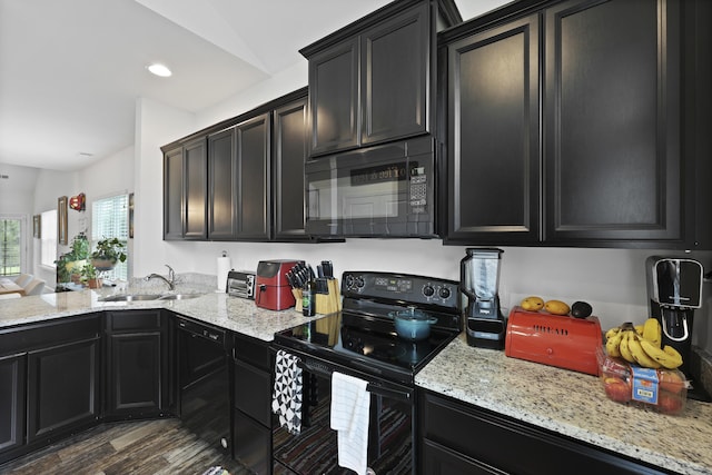 192 Buchanan Cir, Goose Creek, SC 29445 - kitchen with black appliances, dark cabinetry, light stone counters, and recessed lighting