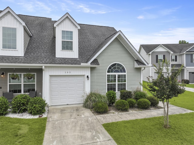 192 Buchanan Cir, Goose Creek, SC 29445 - view of front of home with board and batten siding, a front lawn, a shingled roof, and driveway