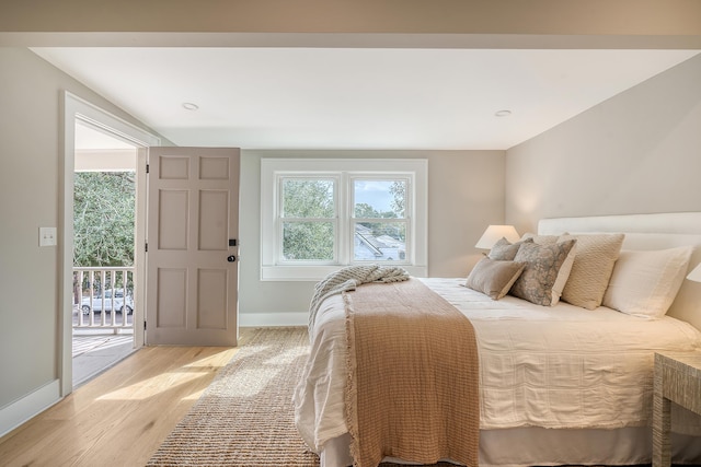 bedroom with access to outside and light hardwood / wood-style floors