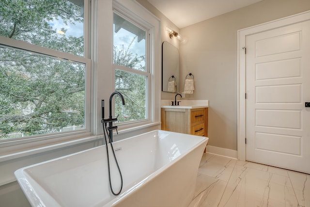 bathroom featuring vanity and a tub