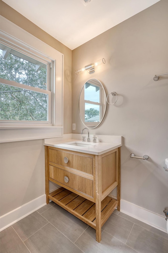 bathroom with tile patterned flooring and vanity