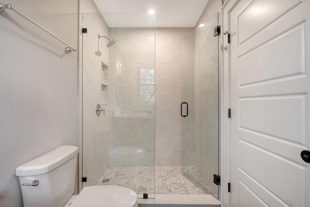 bathroom with toilet and walk in shower