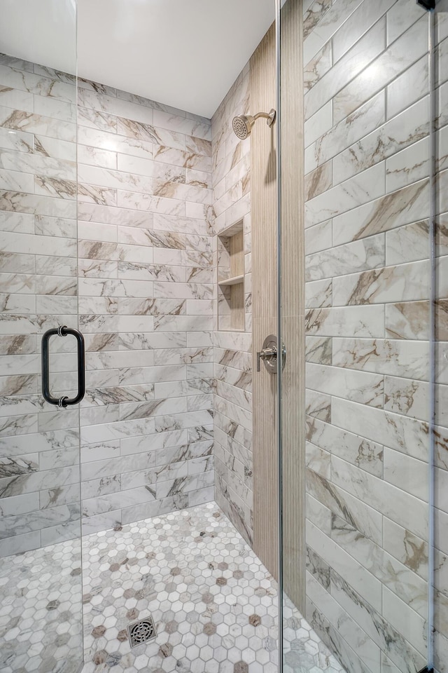 bathroom featuring a shower with door