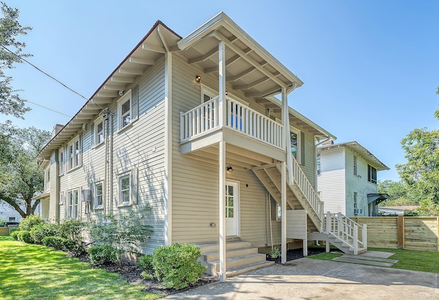 view of side of property with a balcony