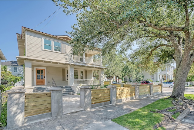 view of front of home featuring a balcony and covered porch