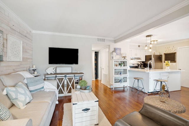 living room with crown molding and dark hardwood / wood-style flooring