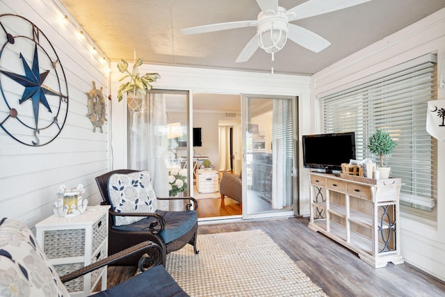 sunroom / solarium featuring ceiling fan