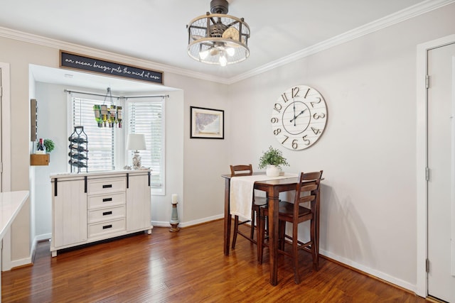 dining room with a notable chandelier, crown molding, and dark wood-type flooring