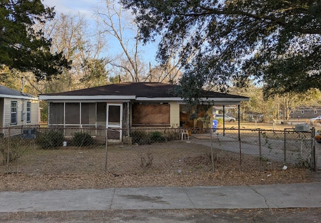 view of front of property with a carport and a sunroom