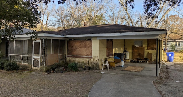 exterior space with a patio and a sunroom