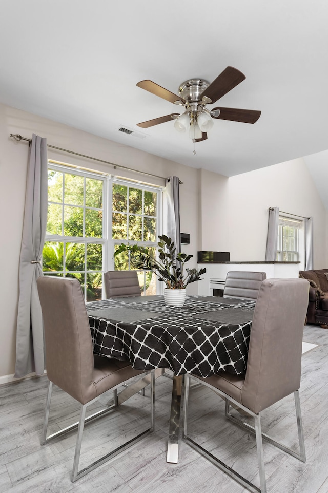 dining space featuring light hardwood / wood-style floors and ceiling fan