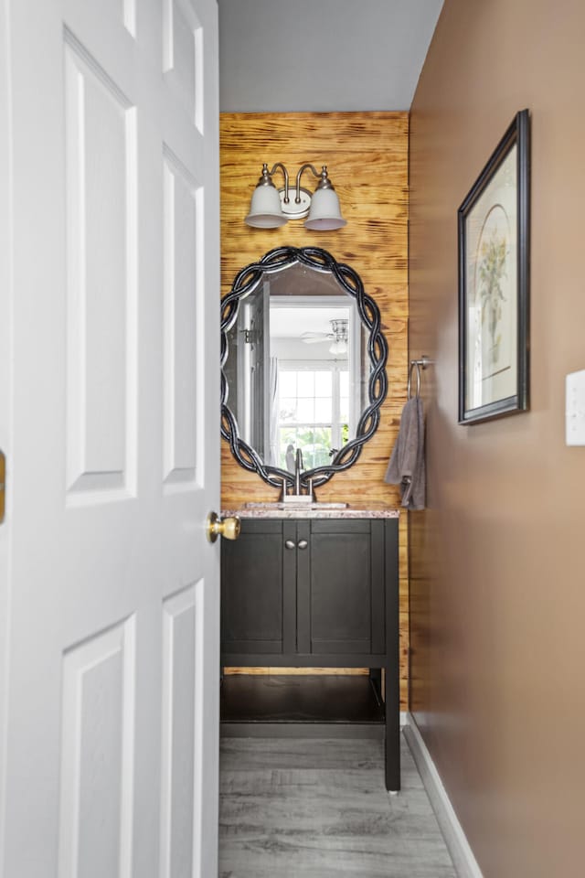 bathroom featuring wooden walls and hardwood / wood-style floors