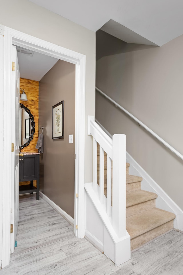 staircase featuring hardwood / wood-style flooring