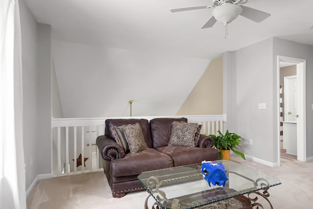 living room with ceiling fan, light colored carpet, and lofted ceiling