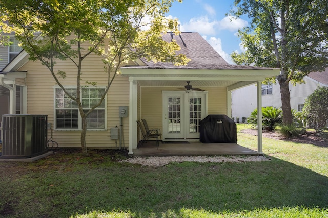 back of property with a patio, a yard, cooling unit, ceiling fan, and french doors