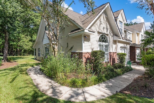 view of side of home featuring a lawn