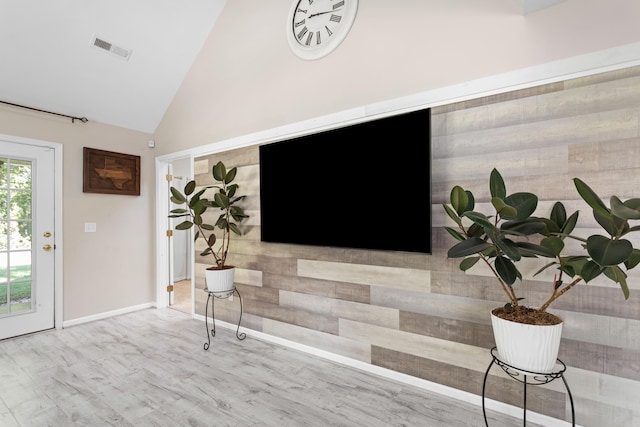 interior space featuring high vaulted ceiling and light hardwood / wood-style floors