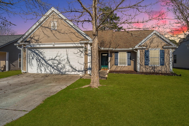 single story home featuring a garage and a lawn