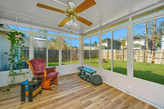 sunroom / solarium featuring ceiling fan, a wealth of natural light, and cooling unit