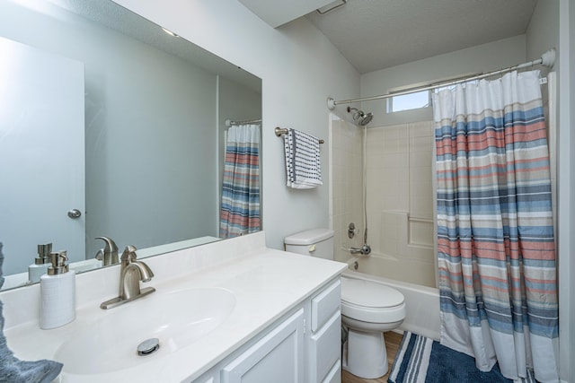 full bathroom featuring shower / bath combo with shower curtain, a textured ceiling, toilet, and vanity