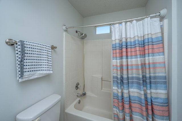 bathroom with a textured ceiling, toilet, and shower / tub combo