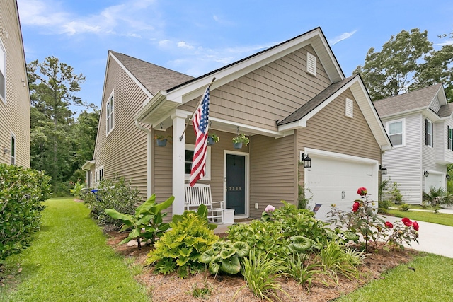 3789 Tupelo Branch Row, Mount Pleasant, SC 29429 - view of front of property with covered porch, an attached garage, concrete driveway, a front yard, and a shingled roof