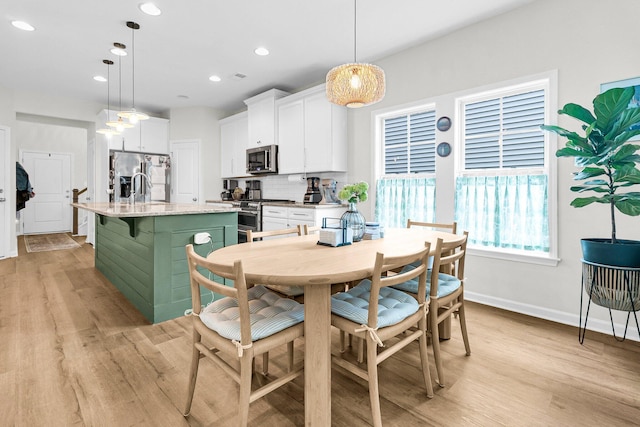 3789 Tupelo Branch Row, Mount Pleasant, SC 29429 - kitchen featuring stainless steel appliances, light wood finished floors, white cabinetry, an island with sink, and recessed lighting