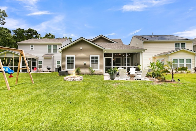 3789 Tupelo Branch Row, Mount Pleasant, SC 29429 - rear view of property with an outdoor fire pit, a sunroom, a lawn, and a patio area