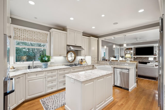 kitchen featuring appliances with stainless steel finishes, white cabinets, a center island, and decorative light fixtures