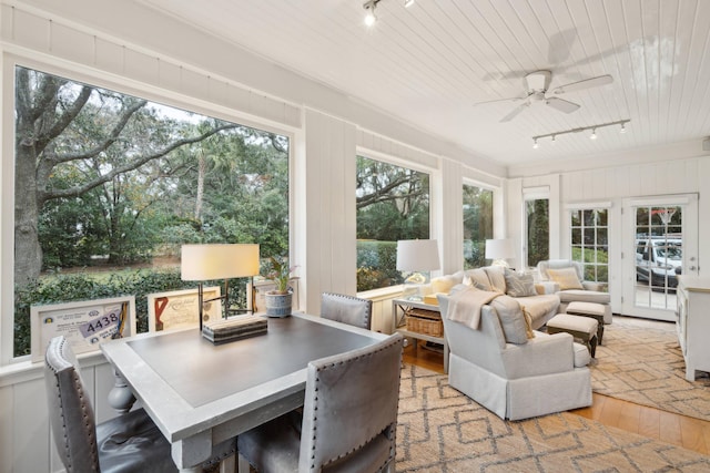 sunroom / solarium featuring track lighting, wooden ceiling, and ceiling fan