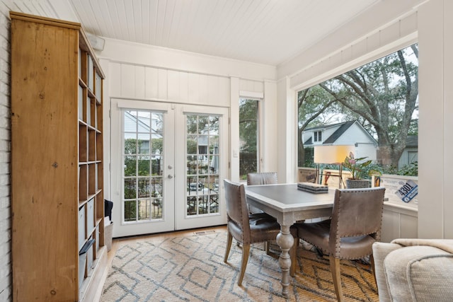 sunroom / solarium featuring french doors