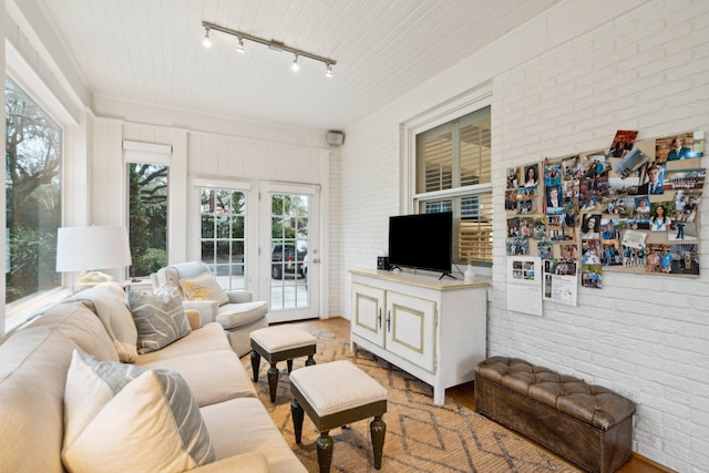 living room with brick wall and rail lighting