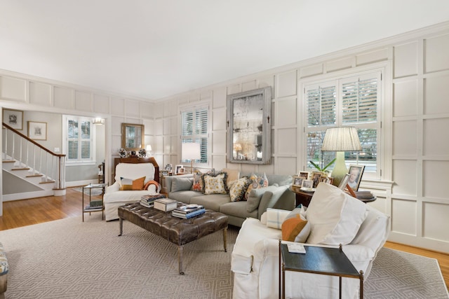 living room featuring ornamental molding and light wood-type flooring