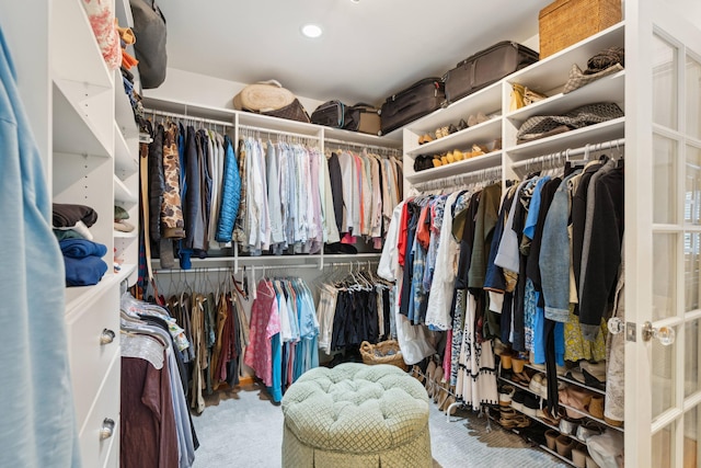 walk in closet featuring carpet