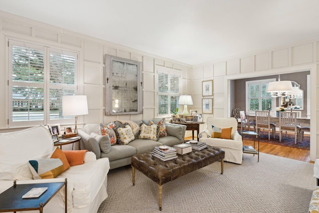 living room with hardwood / wood-style flooring, a wealth of natural light, and crown molding