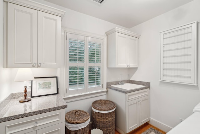 washroom featuring light wood-type flooring and sink